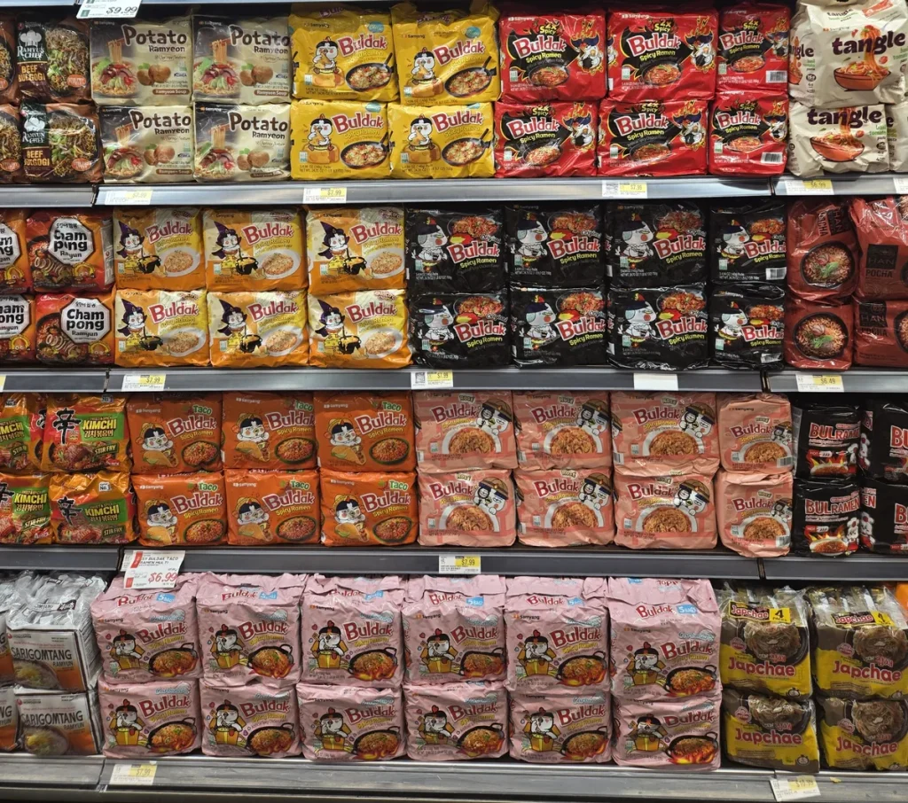 Buldak spicy Korean ramyun varieties displayed on a grocery store shelf